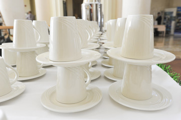 Closeup of cups and saucers in a row