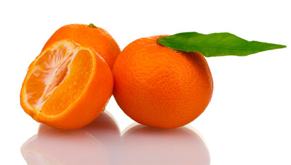 Ripe tasty tangerines with leaves and segments isolated on white
