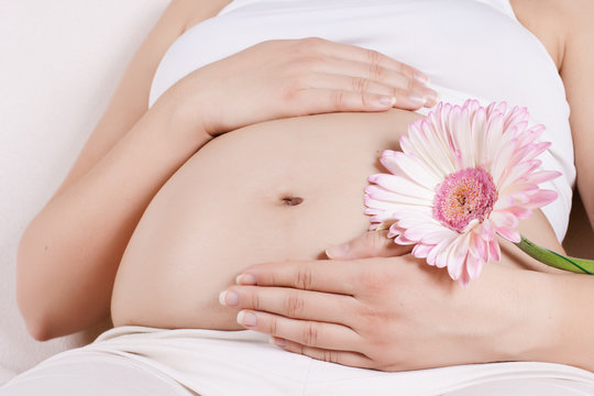 pregnant woman touching her tummy