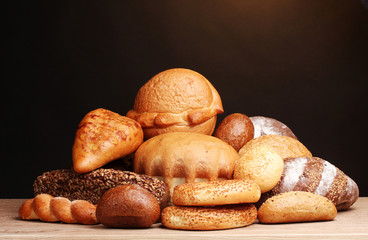 delicious bread on wooden table on brown background