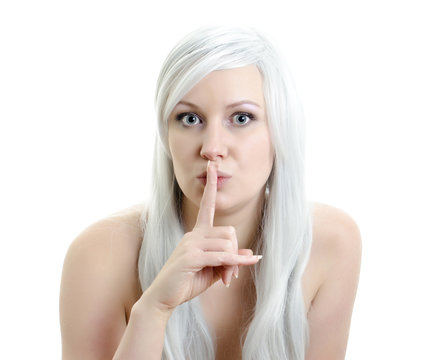 blond girl with a finget at lips isolated on white