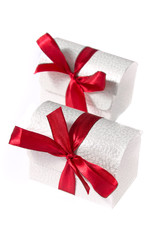 Two white boxes with  ribbons isolated on white
