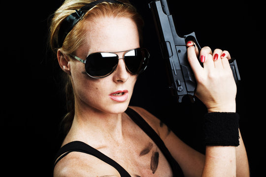 Shot of a sexy military woman posing with gun