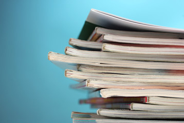 stack of magazines on blue background