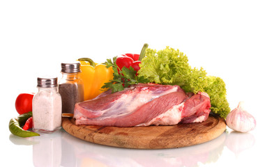 Raw meat and vegetables on a wooden board isolated on whitе