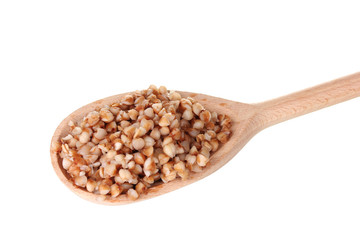 Wooden spoon with boiled buckwheat isolated on white