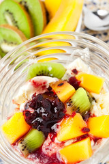 icecream in a bowl with tropical fruits topping