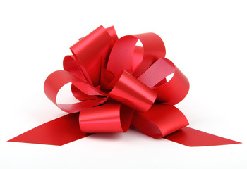 Single red ribbon plastic gift bow isolated on white background. - obrazy, fototapety, plakaty
