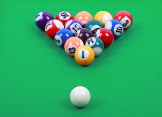 colored billiard balls on green table