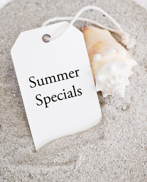 Summer Sales Tag on Sand with Shell