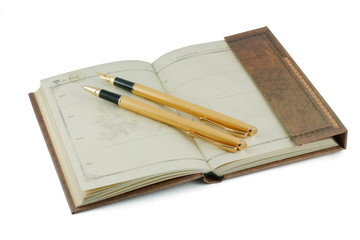 an old notebook and pen gold