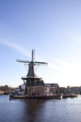 Fototapeta na wymiar Classic windmill at canal in The Netherlands