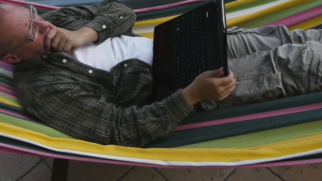 Male - Working with Notebook on Hammock