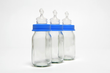 Three empty baby bottles in a row