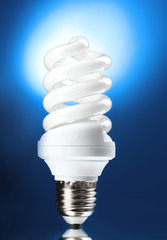 Energy saving lamp on blue background