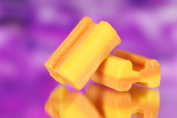 tasty bubble gum on purple background