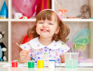 little girl paints paints