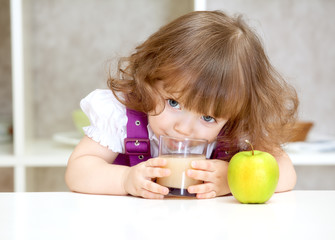 little girl drinking apple juice