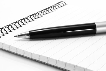 Notepad with ball pen on a white background