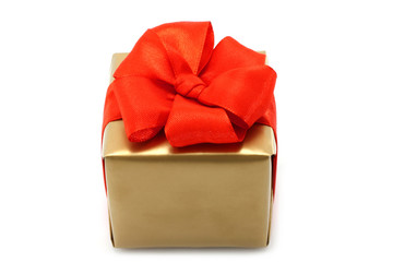 Gold present box with red bow on a white background