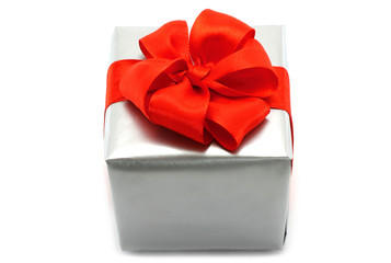 Silver present box with red bow on a white background
