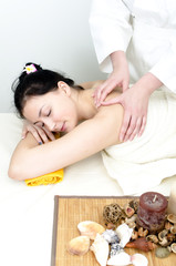 Obraz na płótnie Canvas Young lady receiving back massage at spa center