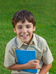 happy school boy with note book