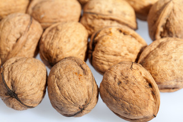 Close up of many scattered walnuts. Background.