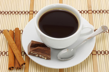 Cup of coffee with chocolate and cinnamon