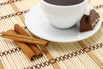 Cup of coffee with chocolate and cinnamon