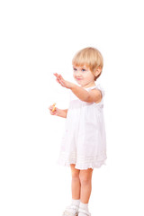 Little girl in white dress with bagel