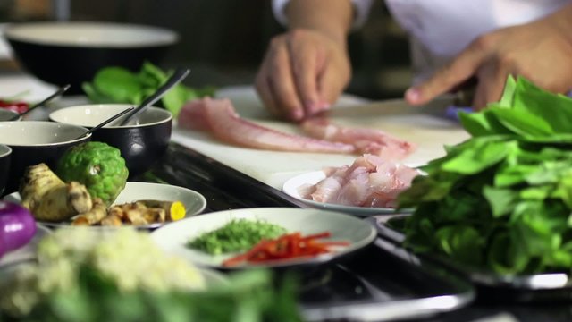 Professional cook working in Asian restaurant kitchen