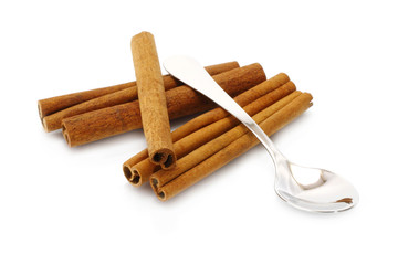 Heap of cinnamon sticks with teaspoon