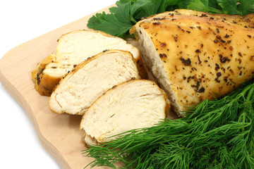 Baked chicken on wooden board close-up