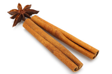 Star anise and cinnamon sticks on white background