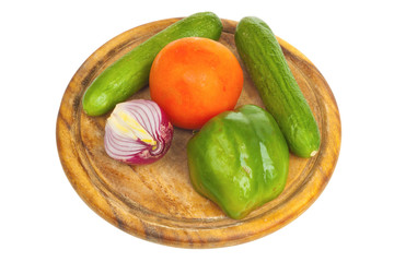 Pepper, onion, cucumber and tomato on a desk