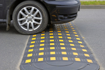 Speed bump on a road when and car