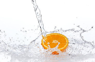 Orange slice in water splash, isolated on white background