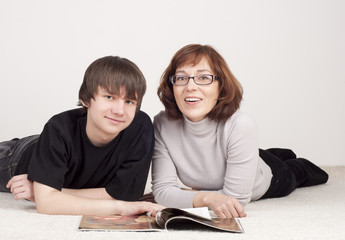 mother and son are together, read magazine