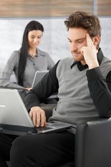 Fototapeta premium Young businessman working on laptop