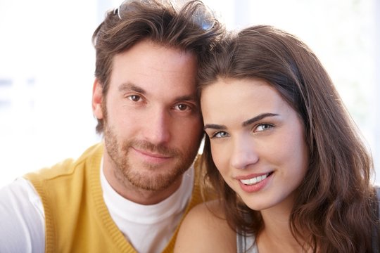 Closeup portrait of attractive couple smiling