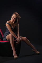 Fototapeta na wymiar brunette girl posing in studio on dark background