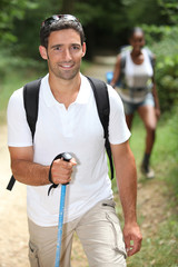 Fototapeta premium Interracial couple hiking in the forest