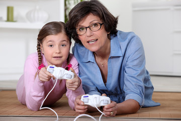 Mother and daughter playing video games