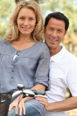 portrait of a couple on a bicycle