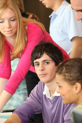 Young man surrounded by his peers