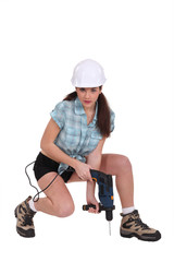 Sexy woman using a power tool