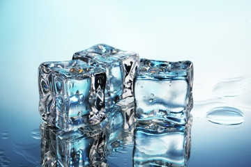 Melting ice cubes on blue background