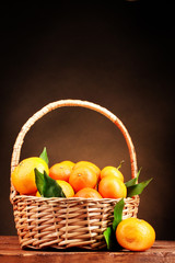 tangerines with leaves in a beautiful basket