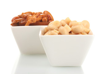 Different marinated mushrooms in white bowl isolated on white